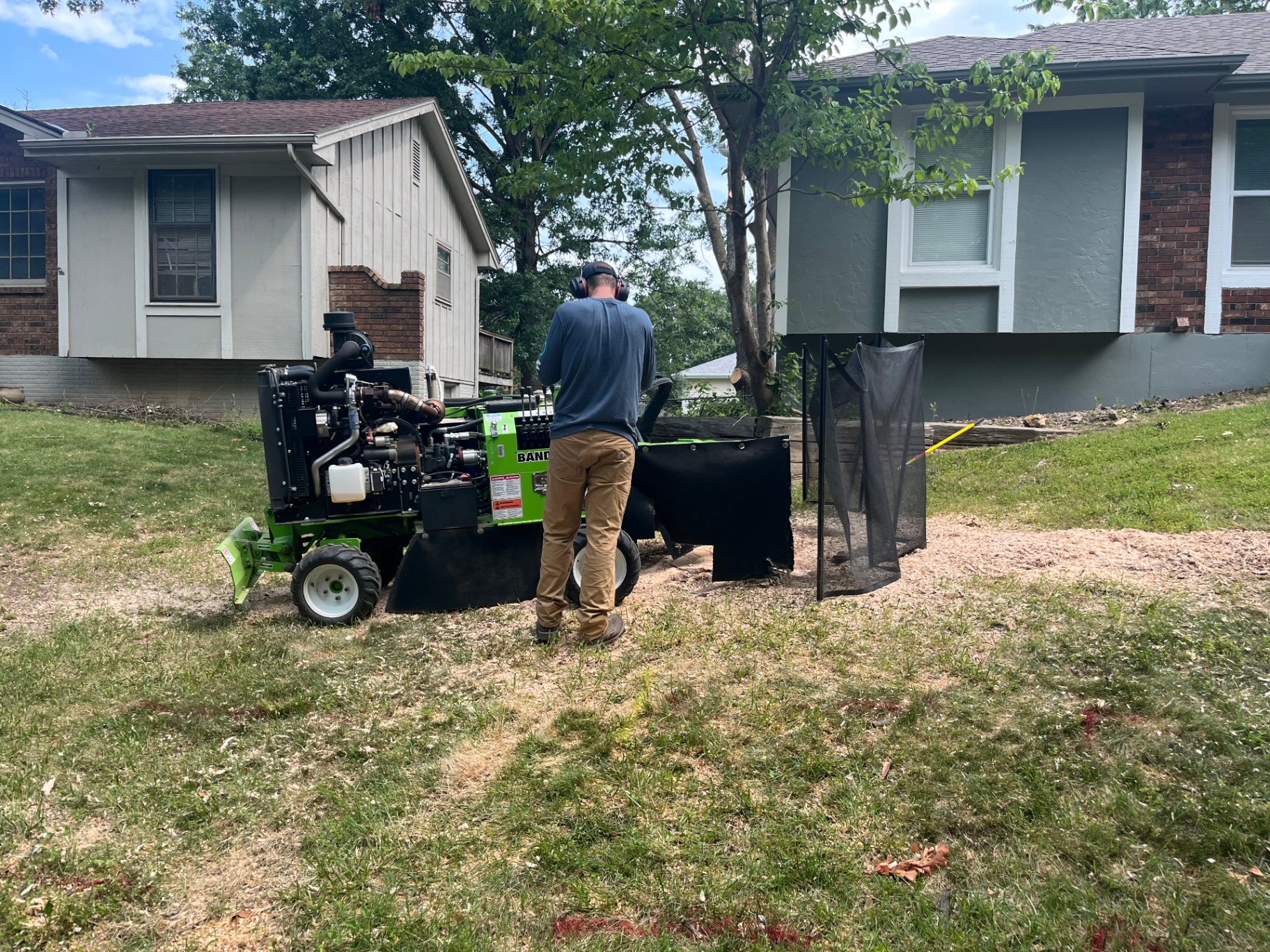 Stump Pros professional operating stump grinder with safety barriers